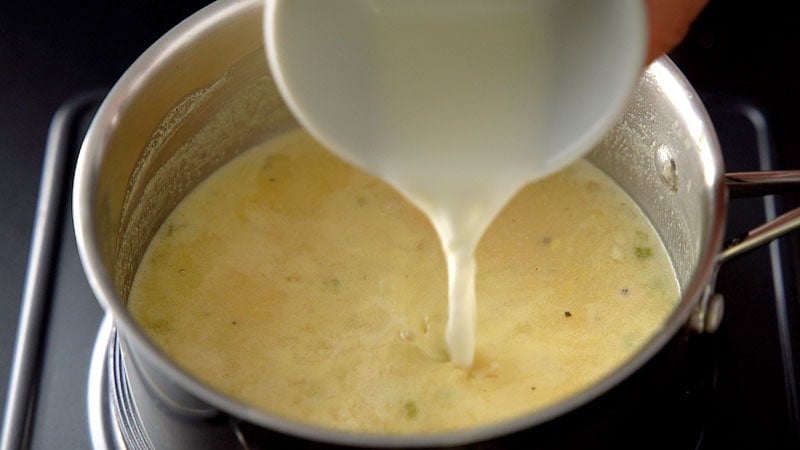 corn starch slurry or paste being added to the corn soup