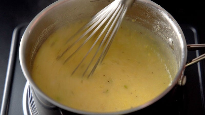 cornflour paste being mixed with a wired whisk