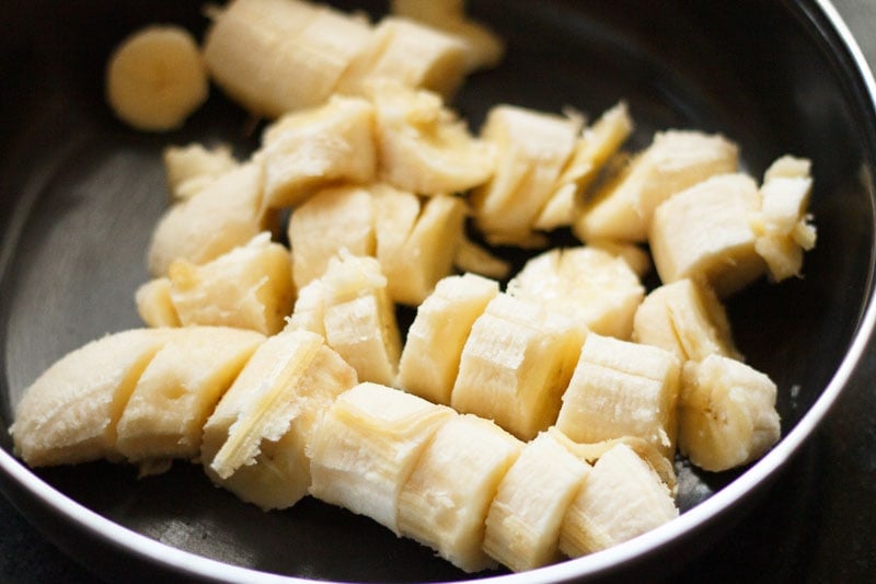 Top shot of sliced bananas in black bowl