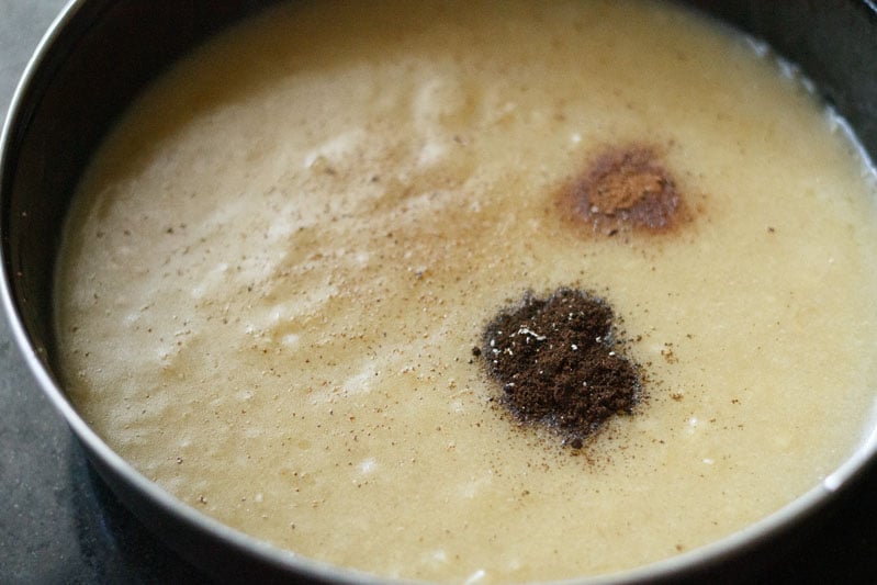 Top shot of banana puree and flavorings in black bowl