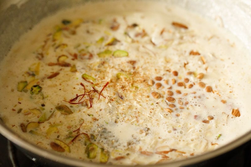 saffron strands and charoli seeds added to basundi