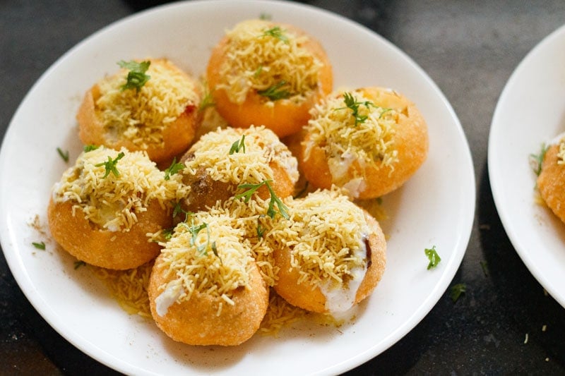 sev and coriander leaves sprinkled on dahi puri