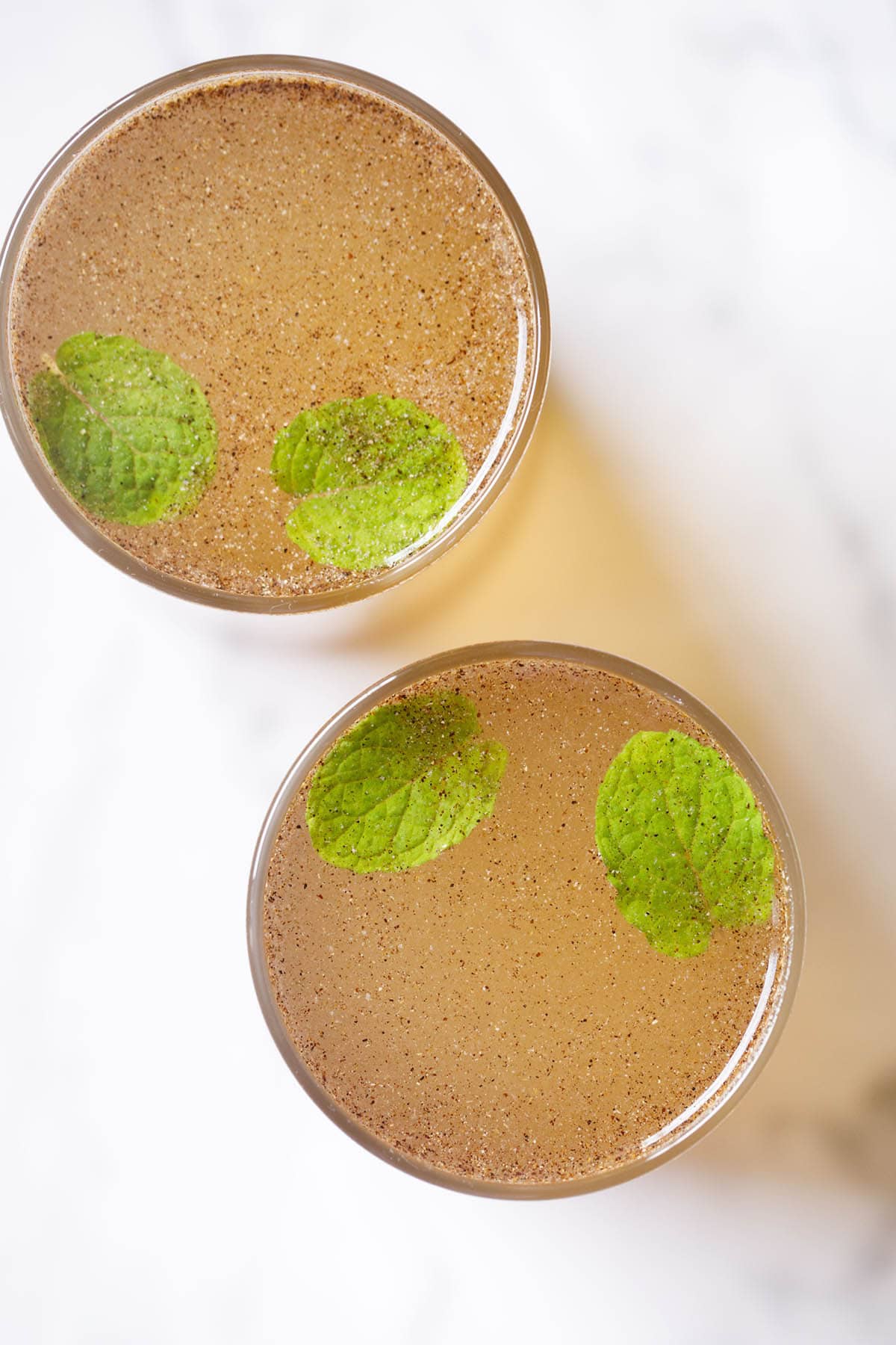 overhead shot of nimbu pani with mint leaves