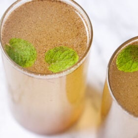nimbu pani in two glasses with mint leaves