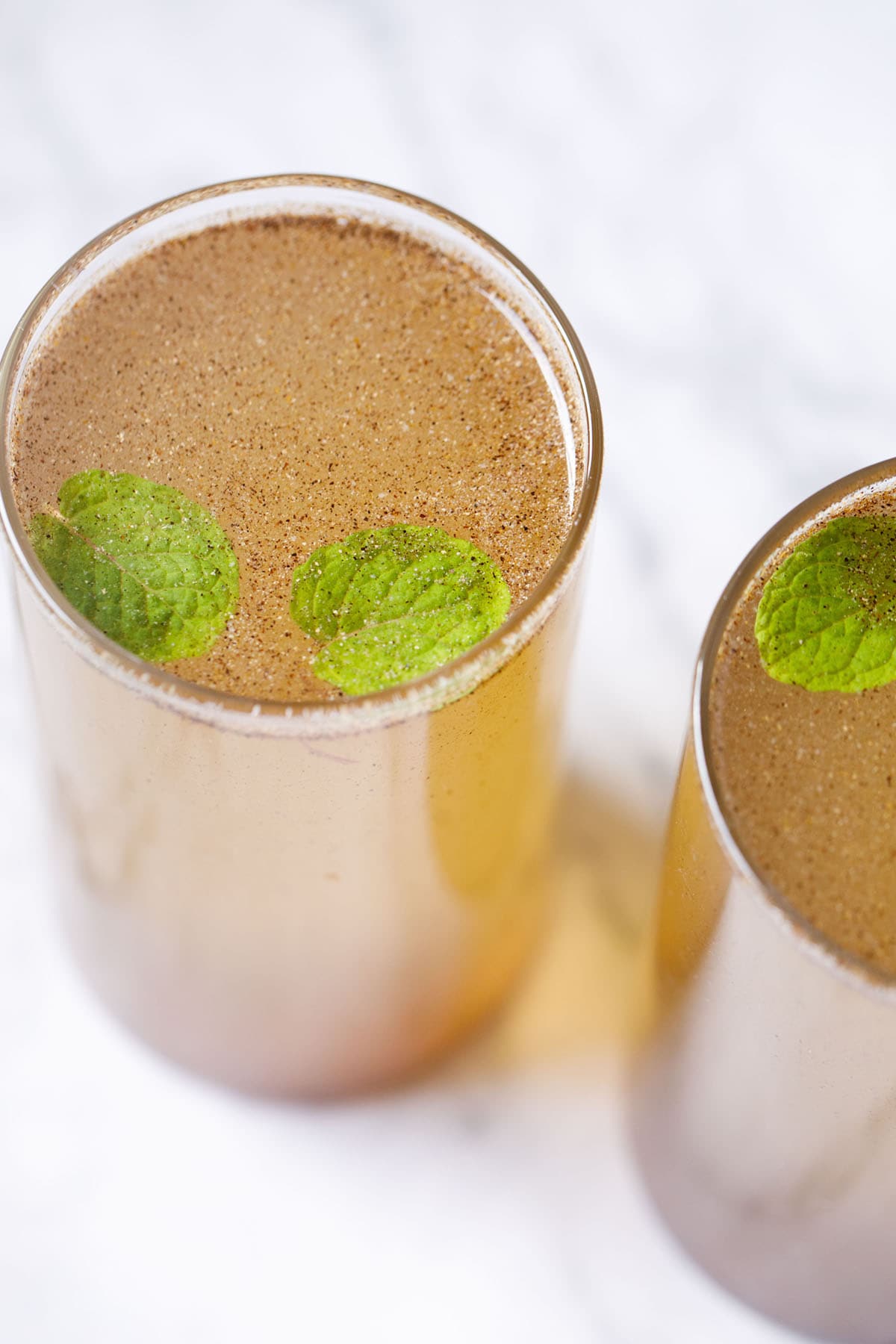 nimbu pani in two glasses with mint leaves