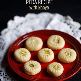 7 peda pieces on a red plate placed on white doilies