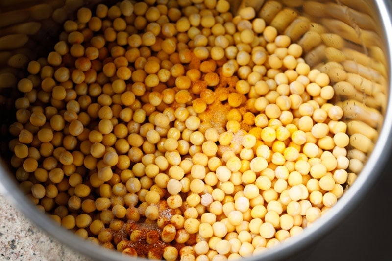 ground spices and salt on soaked white peas