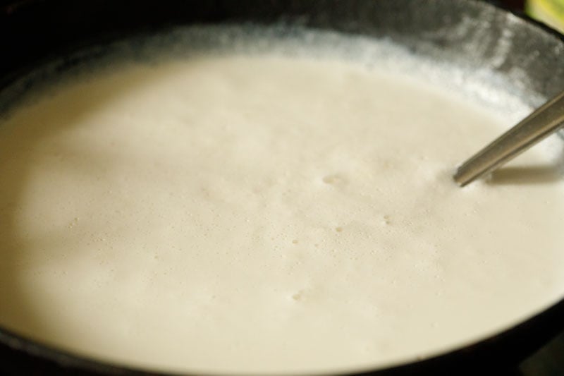 spoon stirring thickened milk