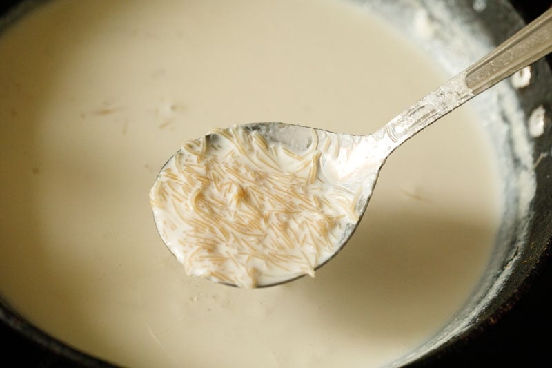 spoon showing texture of pasta after simmering