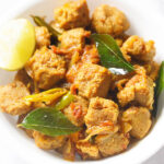 closeup shot of soya chunks fry in a white bowl with a lemon wedge