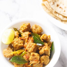 soya chunks fry in a white bowl with a lemon wedge