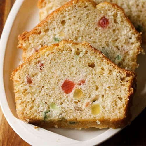 tutti frutti cake slices on a white oval platter