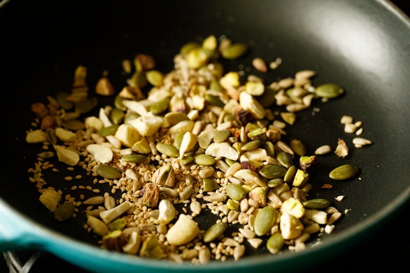 raw nuts and seeds added to pan