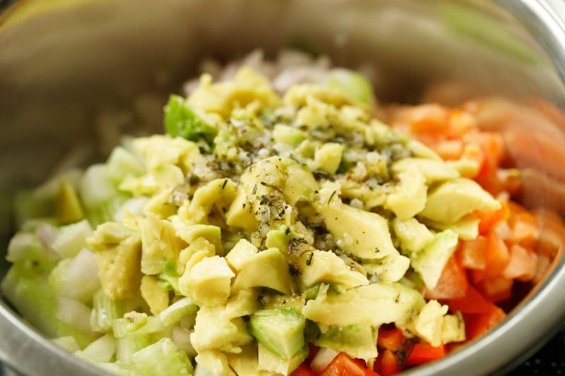 avocado and dressing added to mixed veggies