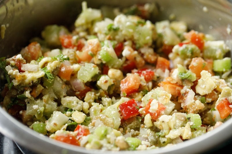 mixed vegetable salad with nuts after tossing in a lemon garlic vinaigrette