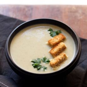one bowl of celery soup with herbs and croutons