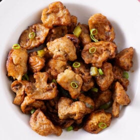 overhead shot of chilli mushroom in a shallow white bowl