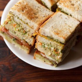 club sandwiches squares with layers seen on a white plate
