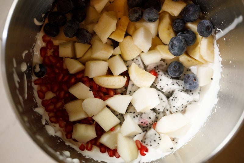 mix fruits on top of whipped cream.