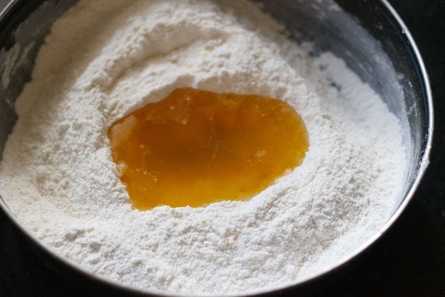 flour, salt, sugar, semolina and ghee in a bowl