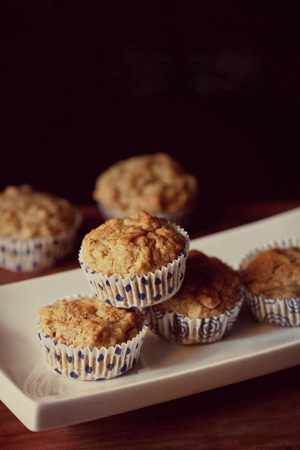 banana muffin placed on top of two banana muffins in a white tray