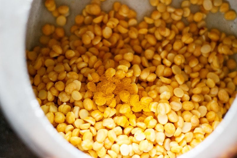 soaked chana dal and turmeric powder in a pressure cooker