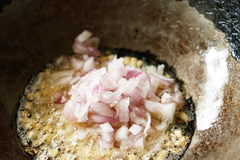 mound of chopped onions in wok