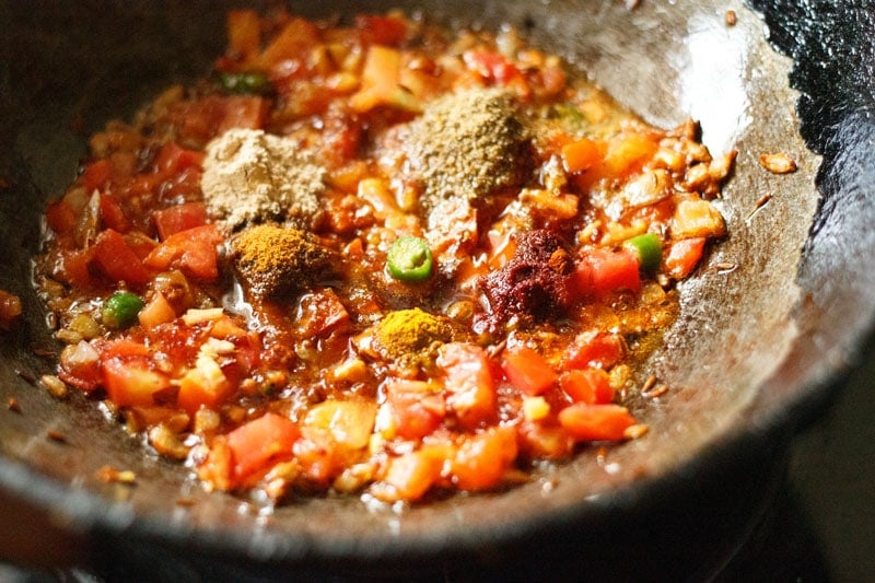ground spices in wok together with onion-tomato masala