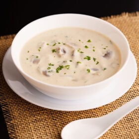 mushroom soup in a white bowl placed on burlap