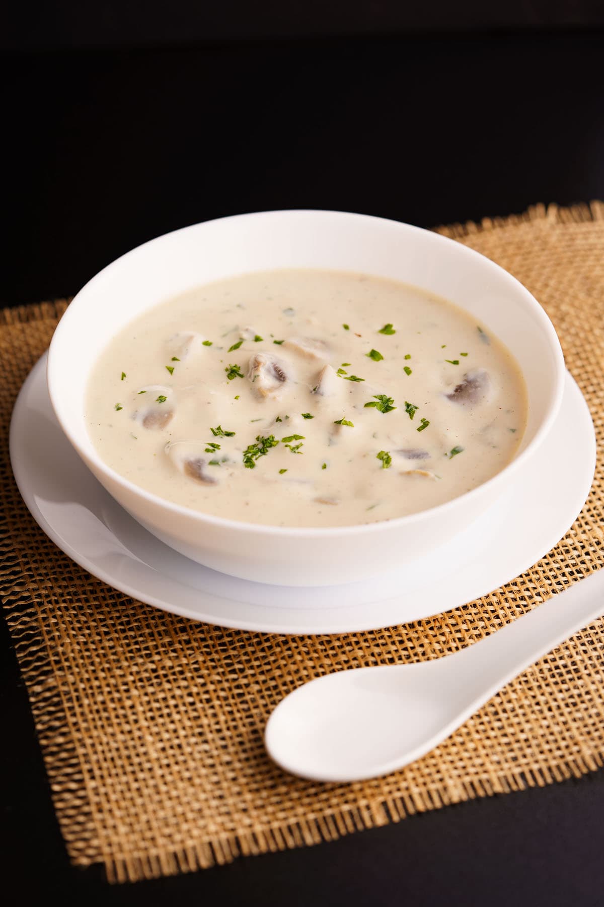 mushroom soup in a white bowl placed on burlap