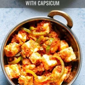 overhead shot of kadai paneer in a small kadai (Indian wok) on a light blue board with text layovers