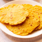 three makki di roti served on a white plate.