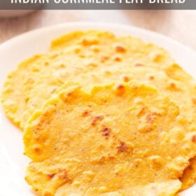 three makki ki roti in a white plate with saag and a salad in white bowls placed on top side with text layovers