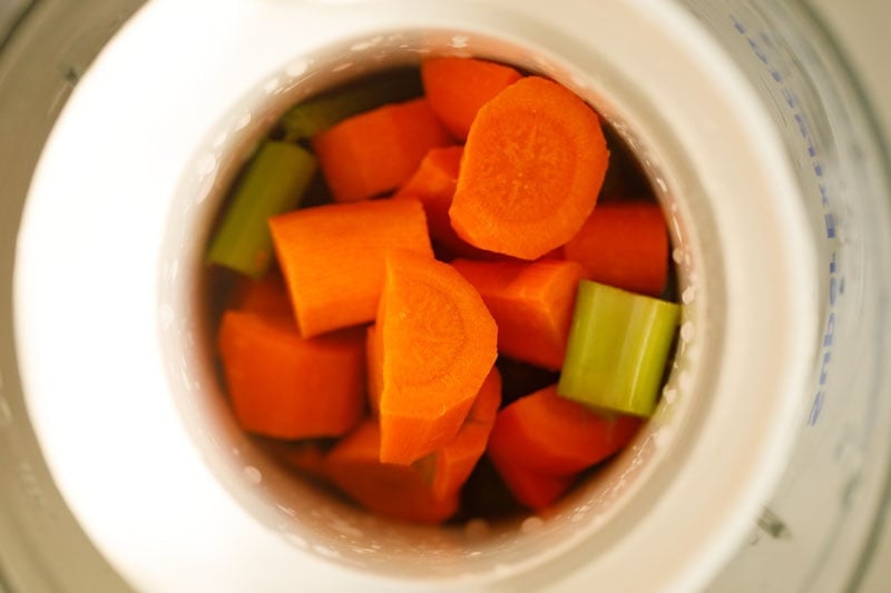 chopped carrots and celery in a grinder mixer bowl.