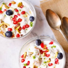 overhead shot of fruit cream in glass bowls with dessert spoons placed on burlap with text layovers