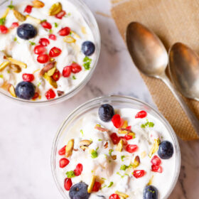 fruit cream in glass bowls with dessert spoons placed on burlap