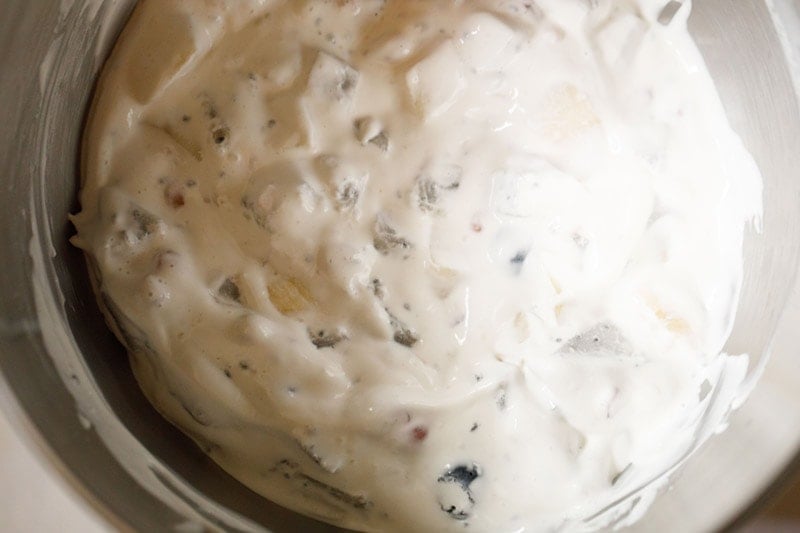 Fruit folded into cream in bowl