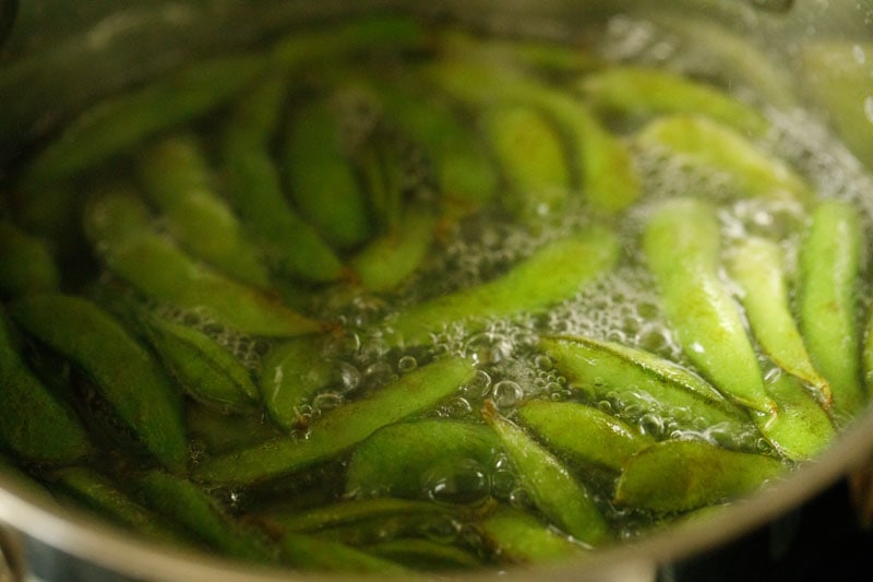 edamame pods added to boiling water.