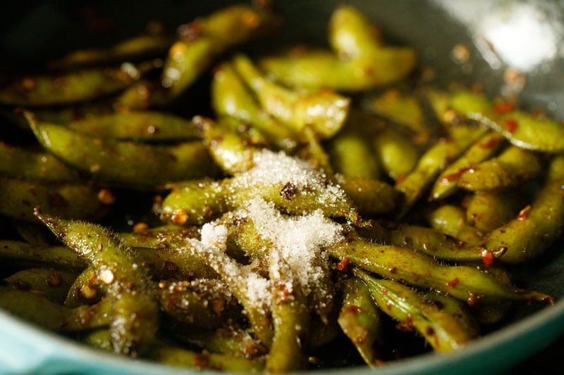 sugar, salt and mirin added to chili garlic edamame pan.