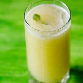 aam panna in glass on a green table.