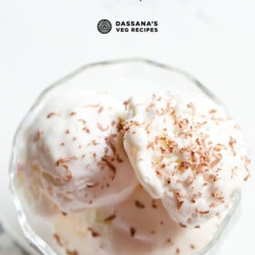 overhead shot of ice cream scoops in a glass bowl with text layovers