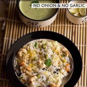 kashmiri biryani in a bowl on bamboo mat with raita and lemons in two bowls with text layovers