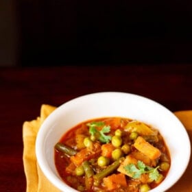 veg kolhapuri served in a white bowl.