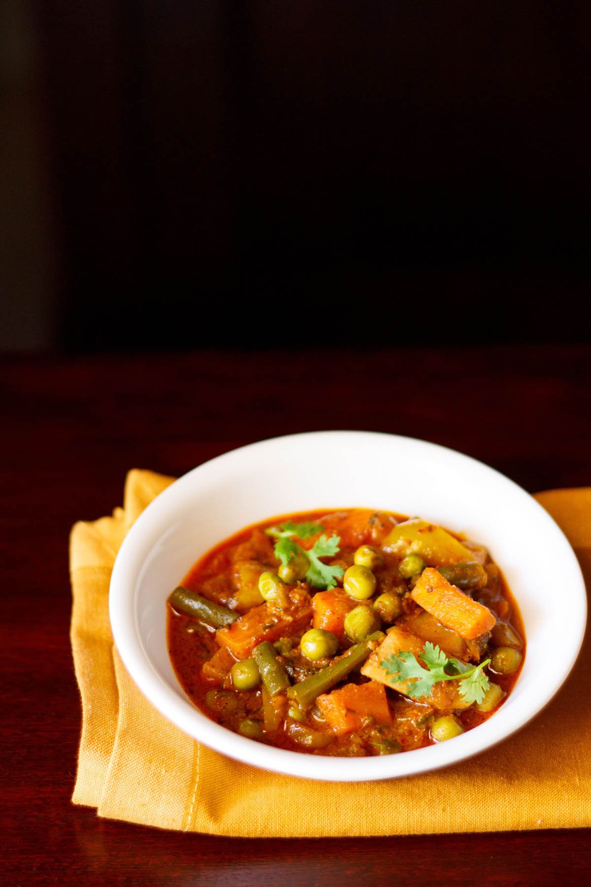 veg kolhapuri served in a white bowl.