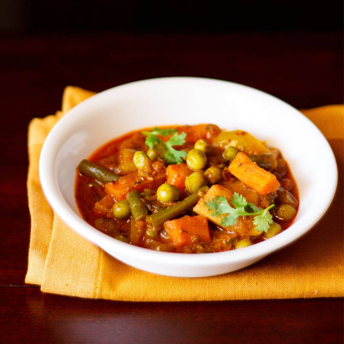 veg kolhapuri served in a white bowl.