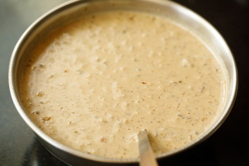 evenly mixed wet dates, walnuts with milk in bowl.