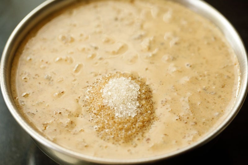 mound of sugar over wet ingredients in bowl.