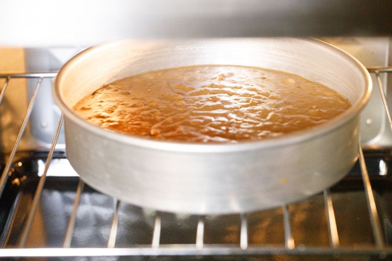 pan with date cake batter in oven.