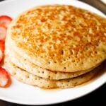 closeup shot of eggless pancakes on a white plate.