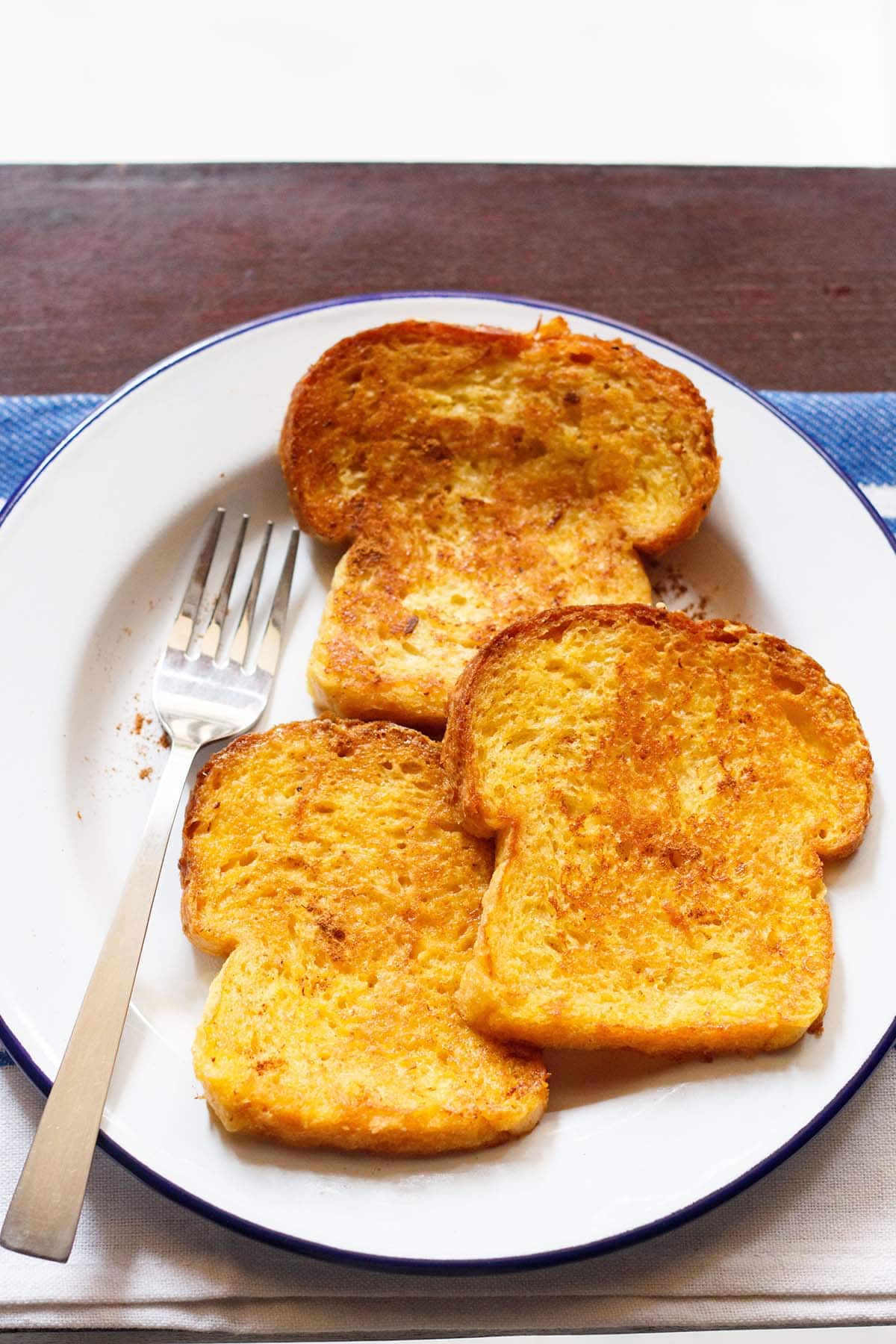 french toast without eggs on a white plate with fork by the side..